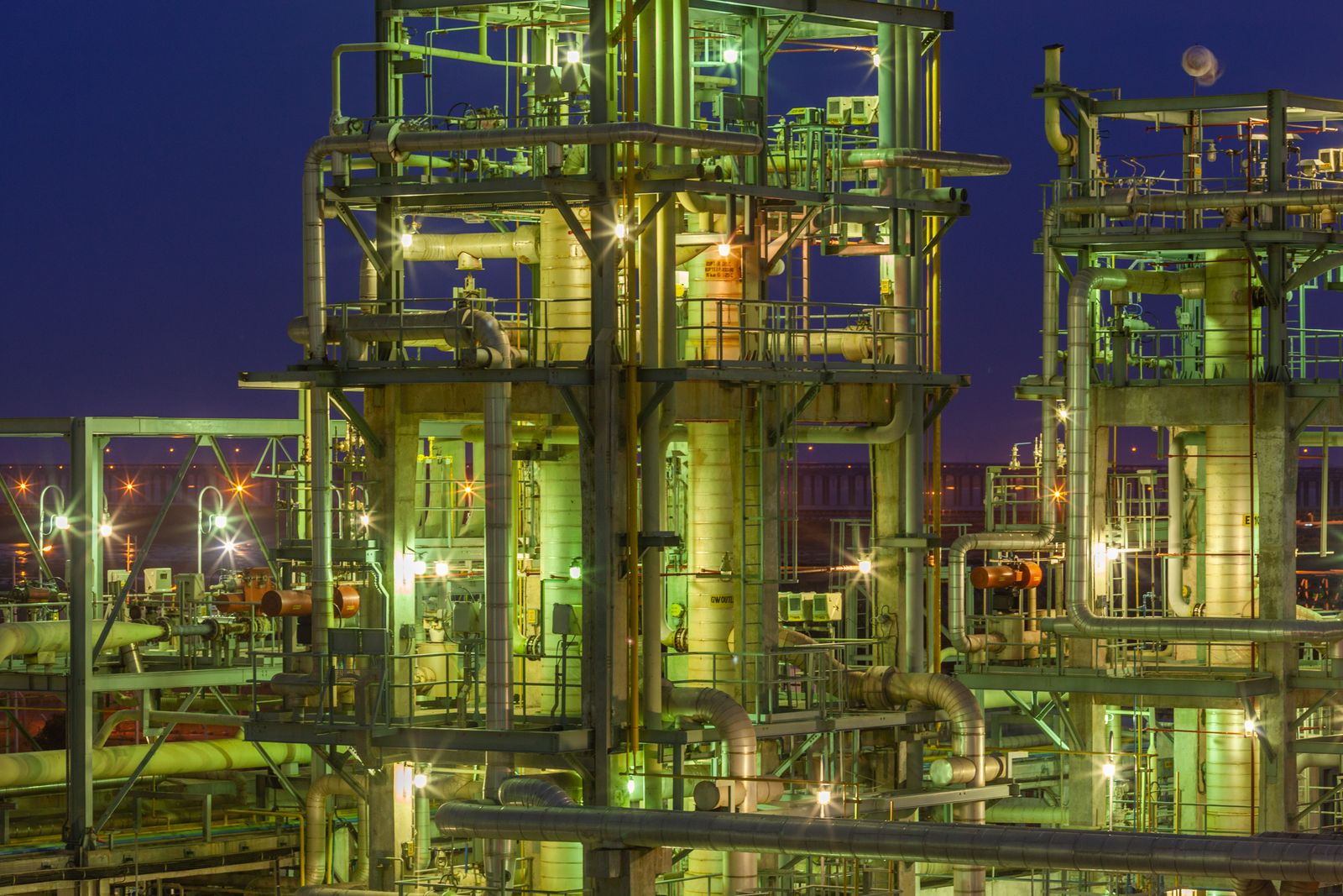 Illuminated industrial gas plant at night