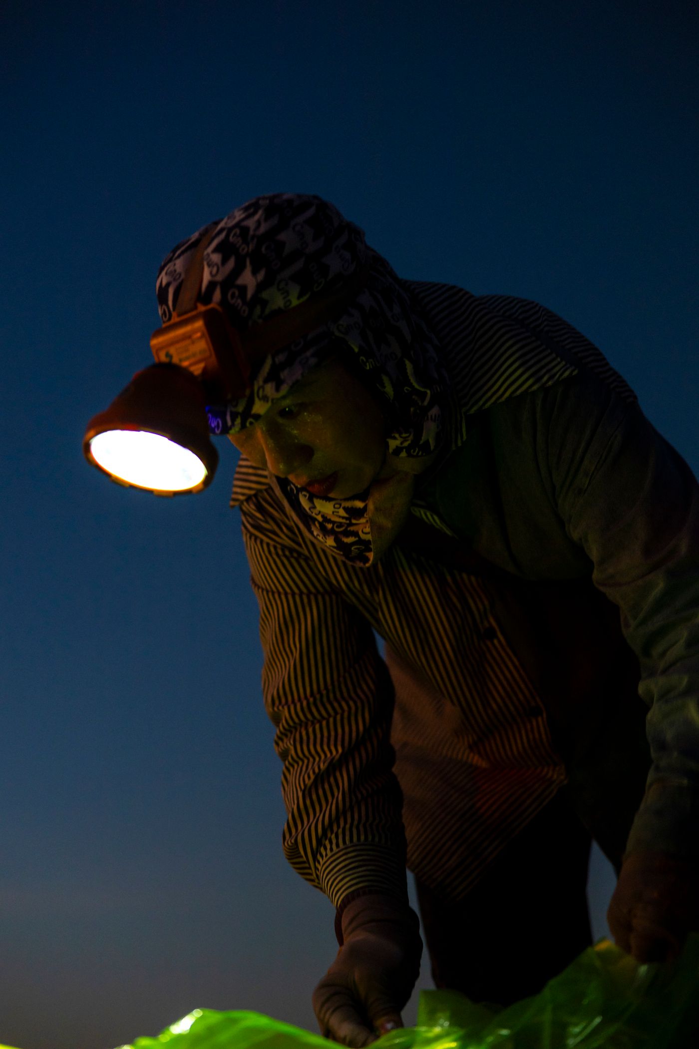 Industrial worker using a headlamp in low light